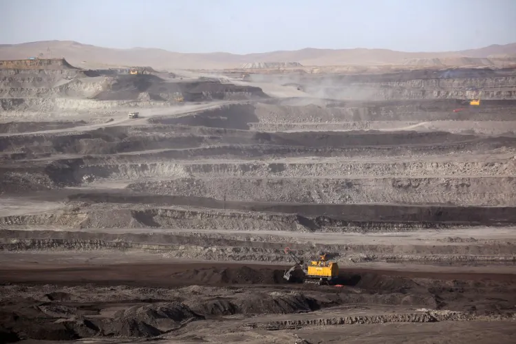 This photo taken on Nov. 15, 2010 shows workers driving trucks at a coal mine in Huo Lin Guo Le, located in China's north Inner Mongolia region. (Gou Yige/AFP/Getty Images)