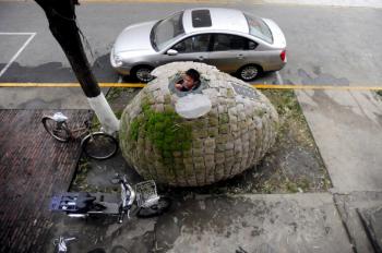Dai Haifei, 24, from China's Hunan province, looks out from his egg-shaped mobile house where he has been living for the last two months, located near his office in Beijing on December 1, 2010. (Getty Images) Dai Haifei, 24, from China's Hunan province, looks out from his egg-shaped mobile house where he has been living for the last two months, located near his office in Beijing on December 1, 2010. (Getty Images)