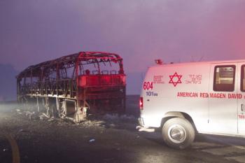 A charred bus that was carrying prison guards on Dec. 2, 2010, near Israel's northern city of Haifa. (Jack Guez/AFP/Getty Images)