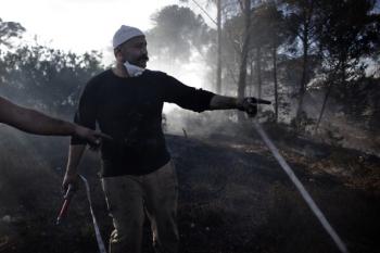 Israeli firefighters control the fire in the village of Ussafiya, in Haifa's Carmel Forest on Dec. 4, 2010. (Marco Longari/AFP/Getty Images)