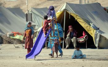 Pakistani flood-affected children play in a relief camp in Sehwan on Dec. 3, 2010. (Rizwan Tabassum/AFP/Getty Images)