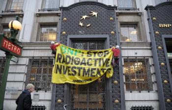 Greenpeace setting up a banner on Dec. 6, 2010 in Paris, to protest against the involvement of French bank BNP Paribas in funding a nuclear project in Brazil. (Bertrand Langlois/AFP/Getty Images)