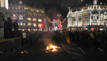 Protesters stand around a fire in Oxford Circus during demonstrations against an increase in fees, in central London, on Dec. 9, 2010. (Carl Court/AFP/Getty Images)