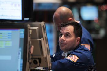 Traders work on the floor of the New York Stock Exchange on December 14,  in New York City. U.S. stock markets gained on Thursday as positive economic indicators boosted investor confidence in the state of the economic recovery. (Spencer Platt/Getty Images)