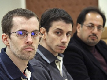 U.S. hikers Shane Bauer (L) and Josh Fattal (C), detained in Iran on spying charges, are sitting next to an unidentified translator during the first session of their trial at the Tehran Revolutionary Court in the Iranian capital on February 6, 2011. (AFP/Getty Images)