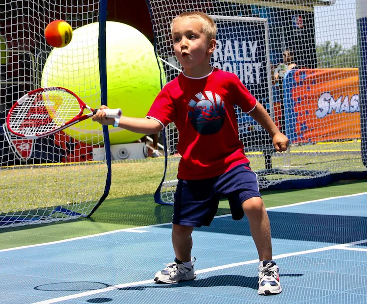 A child tries out the new smaller, lighter racquets during a 10 and Under Tennis demonstration in Atlanta, GA over the summer. (Courtesy of the USTA)