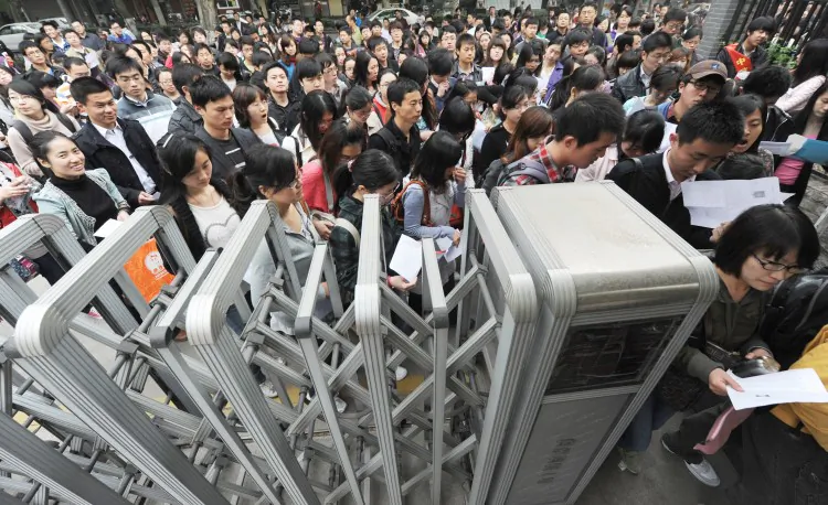 People swarm into the Nanjing Female Technical Secondary School for the Civil Service Exam last year in Nanjing, Jiangsu Province. Over 1.5 million candidates were said to have applied for the exams this year, in what Internet commentators thought was an unhealthy phenomenon in Chinese society. (ChinaFotoPress/Getty Images)