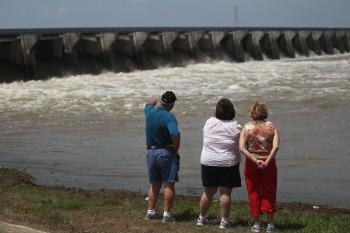 People look on as water from the rising Mississippi River is released through the Bonnet Carre Spillway May 9 in Norco, Louisiana. (Mario Tama/Getty Images)