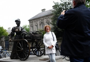 A tourist poses for a picture in front of the statue of Molly Malone in Grafton Street, Dublin, Ireland. (Getty Images)