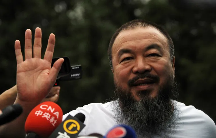 Outspoken Chinese artist Ai Weiwei waves to reporters outside his studio in Beijing on June 23.  (Peter Parks/AFP/Getty Images)