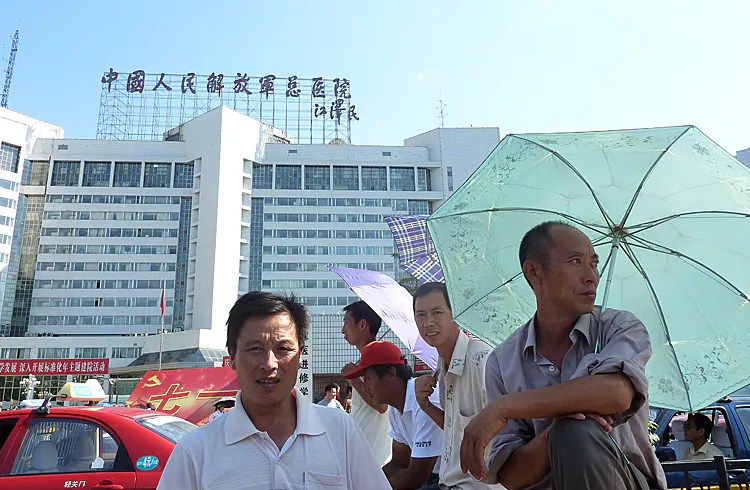 Men stand at the entrance of the 301 Military Hospital in Beijing, where top Chinese leaders often receive medical care, in July 2011. (Liu Jin/AFP/Getty Images)