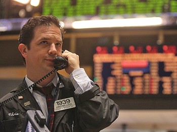 TOUGH CALL: A trader makes a phone call on the floor of the New York Stock Exchange last Thursday. Investors will be looking at the second quarter earnings season, which begins this week, for guidance on the economic recovery. (Mario Tama/Getty Images)