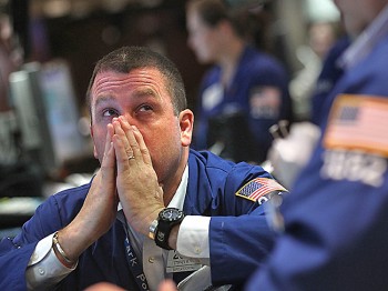 VOLATILE TRADING: A floor trader looks on at the New York Stock Exchange before the closing bell on July 8, after the U.S. Labor Department announced a dismal June jobs report. (Mario Tama/Getty Images)