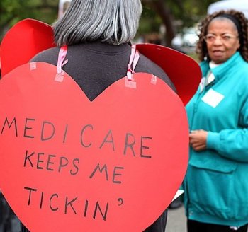 ENTITLEMENTS: A senior citizen holds a sign during a rally to protect federal health programs at the 8th Annual Healthy Living Festival in Oakland, Calif., July 15. (Justin Sullivan/Getty Images)