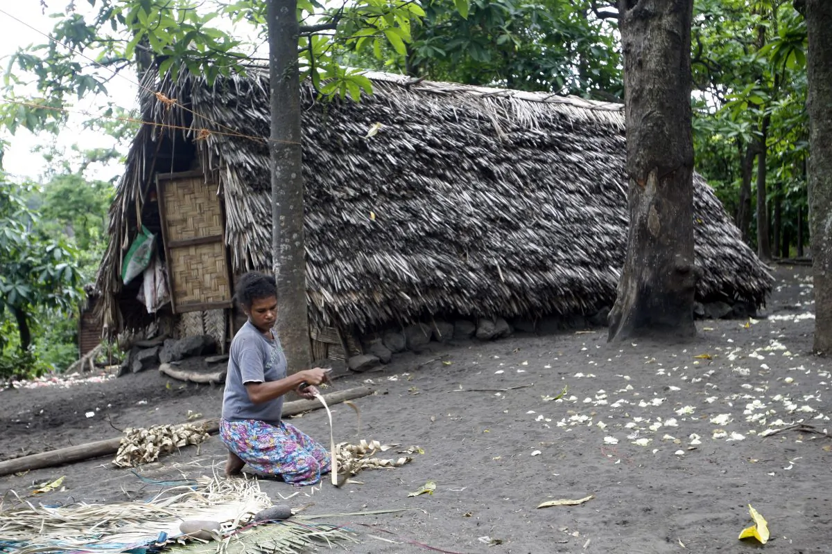 A woman weaves a mat in a village on Tanna Island in Vanuatu, on June 2, 2015. (Nick Perry/AP Photo)