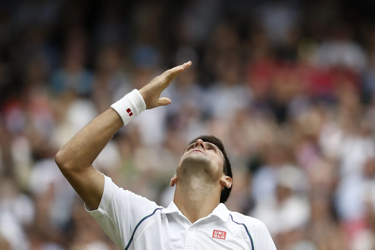Serbia's Novak Djokovic celebrates beating Switzerland's Roger Federer during their men's singles final match on Centre Court on day thirteen of the 2015 Wimbledon Championships at The All England Tennis Club in Wimbledon, southwest London, on July 12, 2015. (Adrian Dennis/AFP/Getty Images)