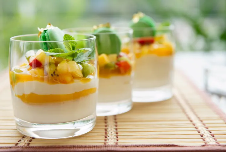Yogurt and fruit salsa is a quick and easy dessert to serve on warm summer days. Layer yogurt and mango puree in drinking glasses. Cut kiwi, strawberries, and peaches into small pieces to make a salsa. Spoon the fruit salsa on top of the yogurt and mango puree. Decorate with a mint leaf and a French macaroon. (Fedor Kondratenko/Photos.com)