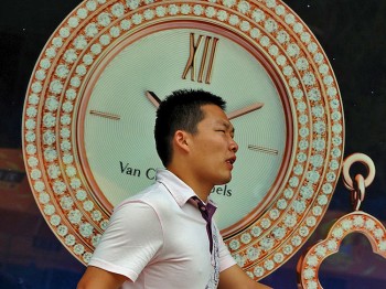 A man walks by a luxury watch store in the Wangfujing shopping street of Beijing on August 9. Luxury watches, far too expensive for Communist Party officials pay scales, can be a sure sign of corruption, writes a former CEO of a joint venture firm. (Mark Ralston/Getty Images)