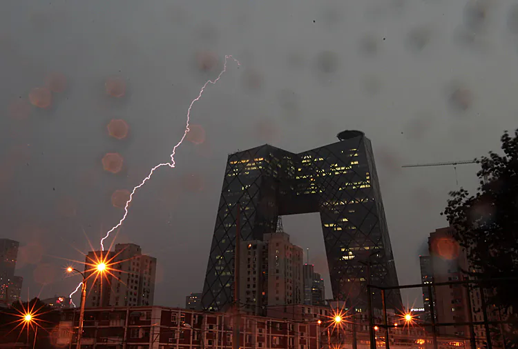 Lightning strikes downtown Beijing in July 2011. In the foreground is the headquarters of the Chinese regime's mouthpiece China Central TV. The political storm raging in Beijing requires each of us to take a stand. (ChinaFotoPress/Getty Images)
