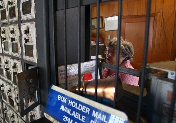 Post Master Maxine Evans sorts the mail after it was delivered by boat to the Ewell Post Office on August 22, 2011. (Mark Wilson/Getty Images)