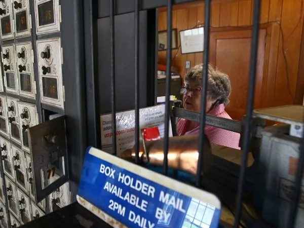 Post Master Maxine Evans sorts the mail after it was delivered by boat to the Ewell Post Office on August 22, 2011. (Mark Wilson/Getty Images)