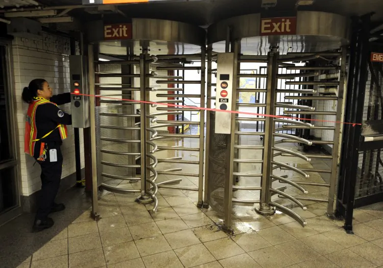 A MTA worker lockes up a gate at Union Square station as the city’s entire mass transit system beginning at noon shut down August 27, 2011 to prepare for Hurricane Irene. It is the first time mass transit has been shut down because of a natural disaster. (TIMOTHY A. CLARY/AFP/Getty Images)