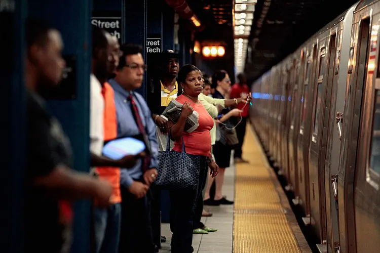 Commuters prepare to board the F train at the Jay Street subway station. (Chip Somodevilla/Getty Images)