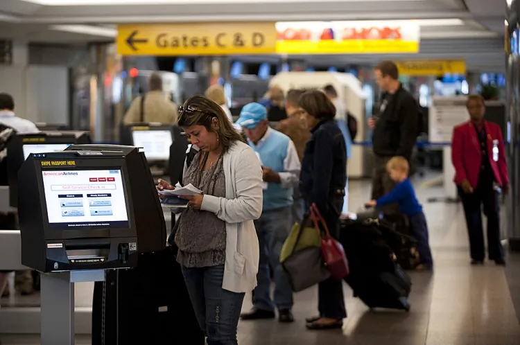 Passengers buy tickets at LaGuardia Airport on Aug. 29, 2011. (Don Emmert/AFP/Getty Images)
