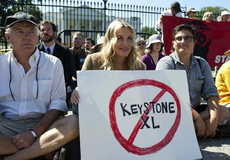 Actress Daryl Hannah (C) sits in front of the White House in Washington, DC, August 30, during a protest against the construction of the Keystone XL pipeline in this file photo. (Saul Loeb/AFP/Getty Images)
