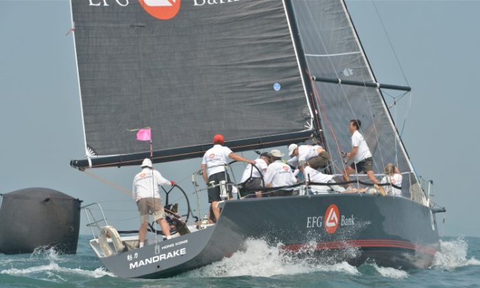‘EFG Bank Mandrake’ from IRC-1 class rounds a marker behind ‘China Cup No. 9’ from IRC-2 during racing on Day 1 of the Royal Hong Kong Yacht Club St Regis International China Coast Regatta on Friday Oct 12. ‘Mandrake’ won her class overall in the three days’ races. (Bill Cox/The Epoch Times)