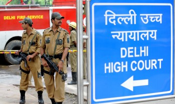 Indian police commandos stand guard in front of Delhi High Court in New Delhi on September 8, 2011. (Raveendran/AFP/Getty Images)