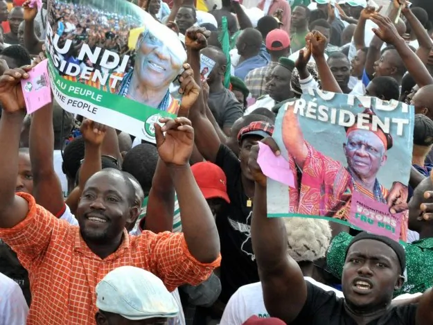 A supporter of Cameroonian opponent John Fru Ndi looks on as he sits on his motorbike adorned with a small flag of his candidate during an electoral meeting in Yaounde on Oct. 8 on the eve of the presidential elections. (SEYLLOU/AFP/GETTY IMAGES)