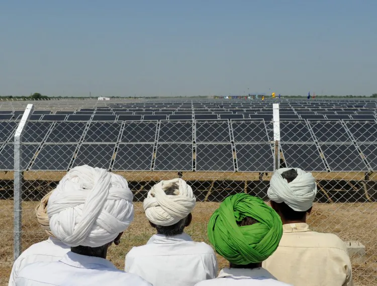 Indian villagers look at solar panels in the village of Gunthawada, Banaskantha district October 14. As the popularity of green technologies grows, solar panels have become targets for thieves who can sell them on the black market. (Sam Panthaky/AFP/Getty Images)