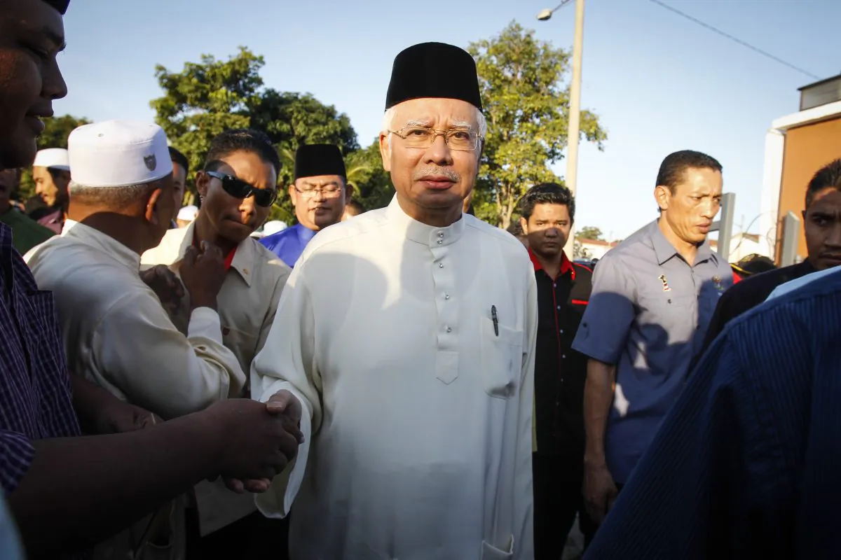 Malaysian Prime Minister Najib Razak arrives for a Ramadan breakfast at a mosque in Semenyih outside Kuala Lumpur, Malaysia on Sunday, July 5, 2015. (AP Photo/Joshua Paul)