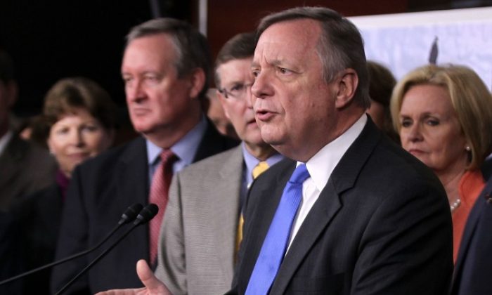 U.S. Senate Majority Whip Sen. Richard Durbin (D-Ill.) speaks as other congressional members, including Sens. Jeanne Shaheen (D-N.H.) (L), Mike Crapo (R-Idaho) (2nd L), Kent Conrad (D-N.D.) (3rd L), and Claire McCaskill (D-Mo.) (R) listen during a news conference on Capitol Hill on Nov. 16, 2011. (Alex Wong/Getty Images)