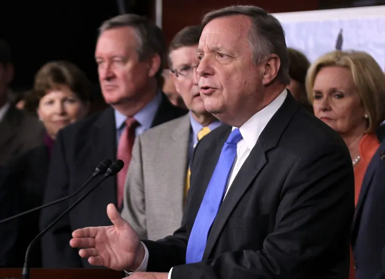 U.S. Senate Majority Whip Sen. Richard Durbin (D-Ill.) speaks as other congressional members, including Sens. Jeanne Shaheen (D-N.H.) (L), Mike Crapo (R-Idaho) (2nd L), Kent Conrad (D-N.D.) (3rd L), and Claire McCaskill (D-Mo.) (R) listen during a news conference on Capitol Hill on Nov. 16, 2011. (Alex Wong/Getty Images)