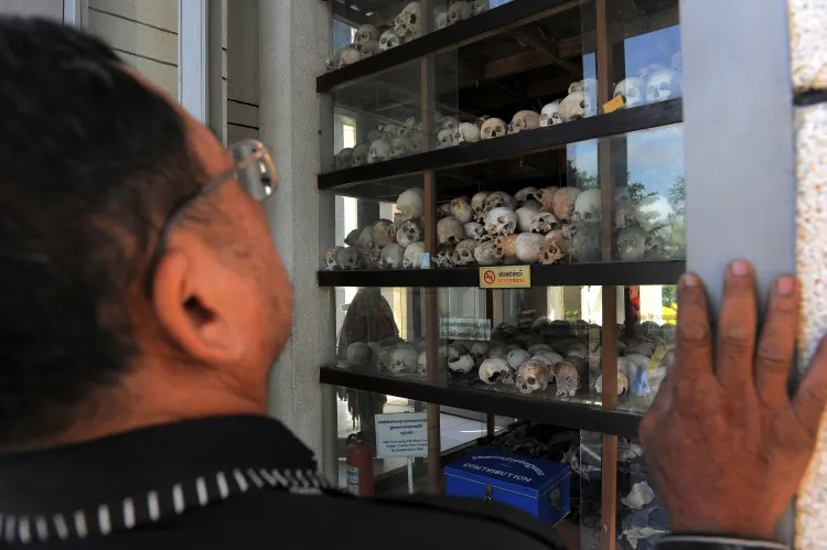A Cambodian man looks at skulls displayed at the Choeung Ek killing fields memorial in Phnom Penh on November 20, 2011. (Tang Chhin Sothy/AFP/Getty Images)