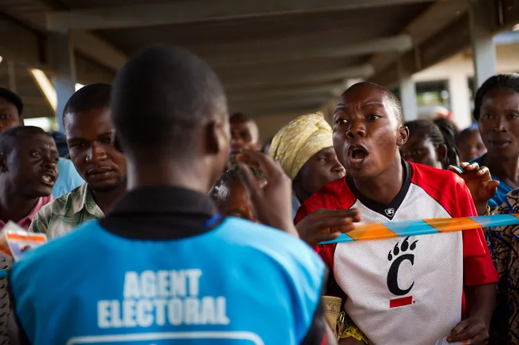 A voter shouts at an election official in the Democratic Republic of Congo on Nov. 29, 2011, at a polling station that was attacked the day before by armed gunmen, who burned all of the ballot papers. (Phil Moore/AFP/Getty Images)