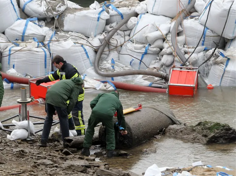 Members of the Rhineland-Palatinate bomb disposal team inspect an bomb found in the River Rhine in Koblenz, on Dec. 3, 2011. (Thomas Frey/AFP/Getty Images)