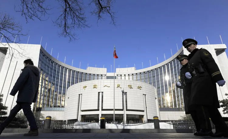 Two Chinese paramilitary police officers (R) patrol in front of the headquarters of the People's Bank of China in Beijing on Dec. 9, 2011. (Liu Jin/AFP/Getty Images)