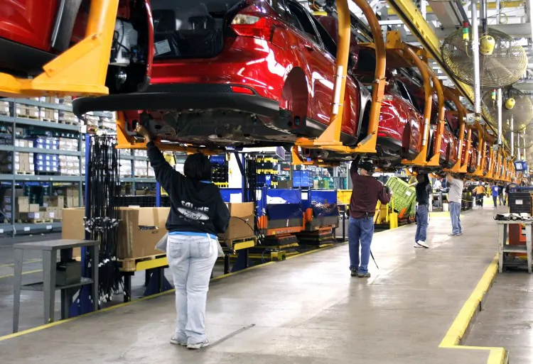 Workers build a Ford Focus on the assembly line at the Ford Motor Co.'s Michigan Assembly Plant December 14, 2011 in Wayne, Michigan in this file photo. General Motors Co., Ford Motor Co., and Chrysler Group LLC all said that December vehicles sales exceeded expectations as consumers shrugged off continued high unemployment rates. (Photo by Bill Pugliano/Getty Images)