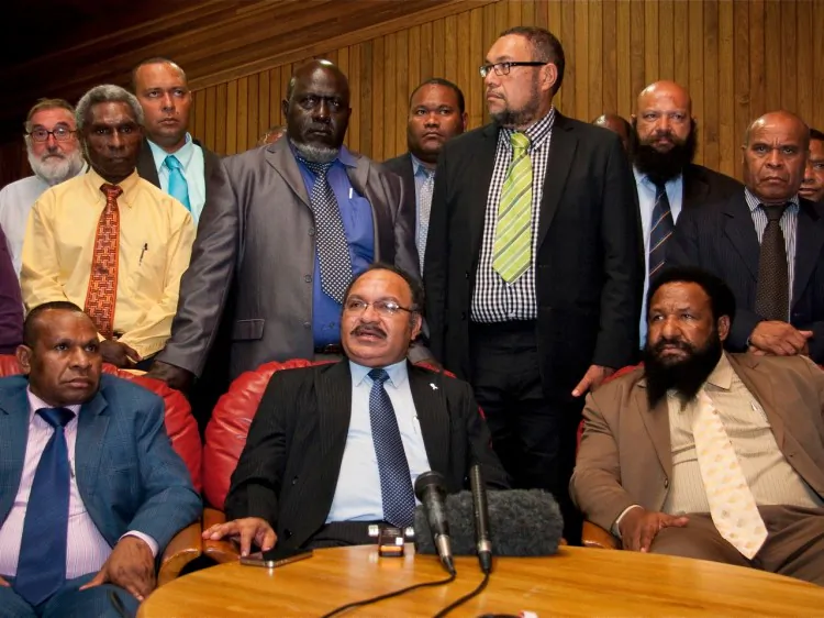 Peter O'Neill (front C) speaks at a press conference in Port Moresby on Dec. 15, 2011. (Ness Kerton/AFP/Getty Images)
