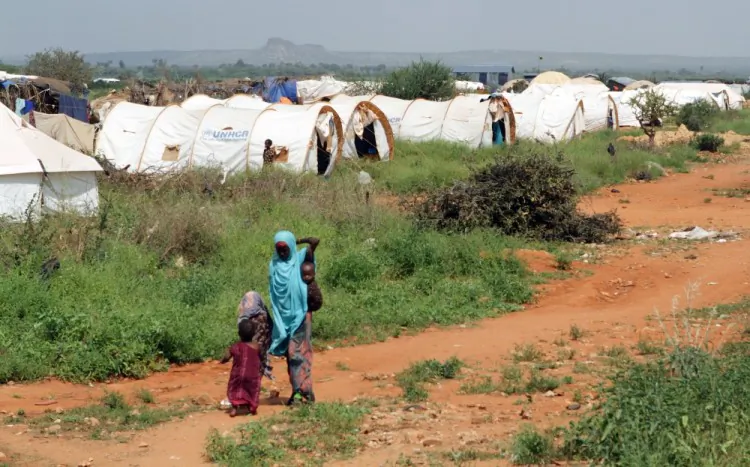 A woman and some children walk through the Hilaweyn refugee camp in Dolo Ado, Ethiopia, in December. (William Davies/AFP/Getty Images)