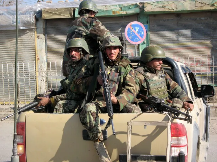 Afghan soldiers arrive at the site of a suicide attack in Kandahar on Jan. 11 (Jangir/AFP/Getty Images)