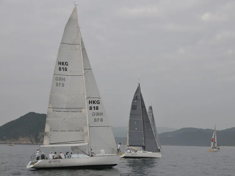 Swapping positions ... ‘Outrageous’ (left) and ‘Mojito’ race in the waters off Hebe Haven. ‘Outrageous’ won the two-day Kowloon Cup 2013 in the HKPN division with ‘Mojito’ second. In the IRC division ‘Mojito’ was the winner and ‘Outrageous’ came second. (Bill Cox/The Epoch Times)