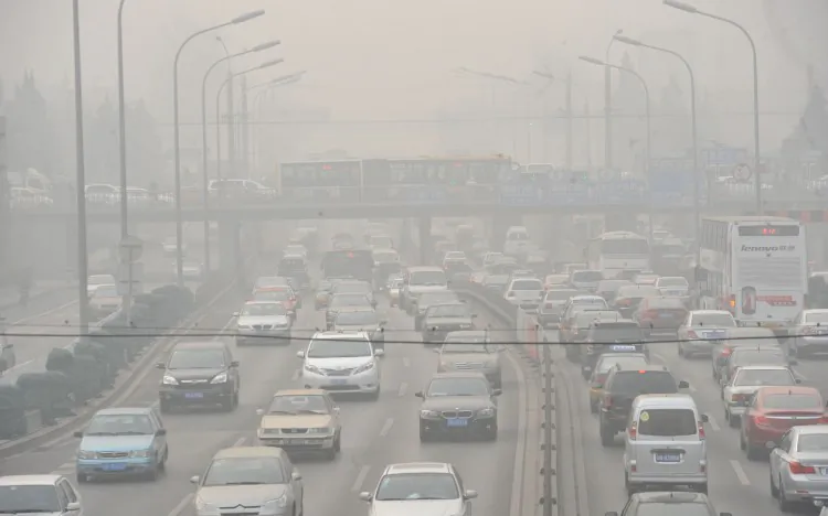 Vehicles drive through smog on a Beijing road on Jan. 18. Pollution from Chinese electric cars could be more harmful to health than that of gasoline vehicles according to researchers at the University of Tennessee. (STR/AFP/Getty Images)