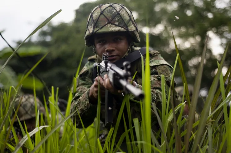 Colombian soldiers conduct a patrol across a field in a mountainous area in Miranda, Cauca department, Colombia, on January 18, 2012. The Colombian army created the Apolo joint task force with area of influence located in the southwestern department of Cauca. TF Apolo is responsible for fighting the Revolutionary Armed Forces of Colombia (FARC). (Luis Robayo/AFP/Getty Images)