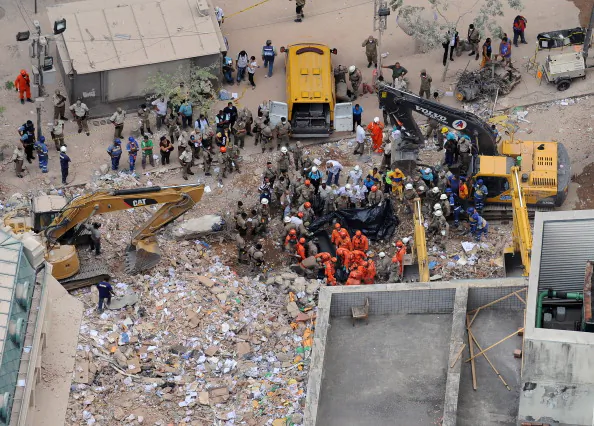 Rescue workers sift through the rubble of three buildings in Rio de Janeiro in Brazil on Thursday. (Vanderlei Almeida/AFP/Getty Images)