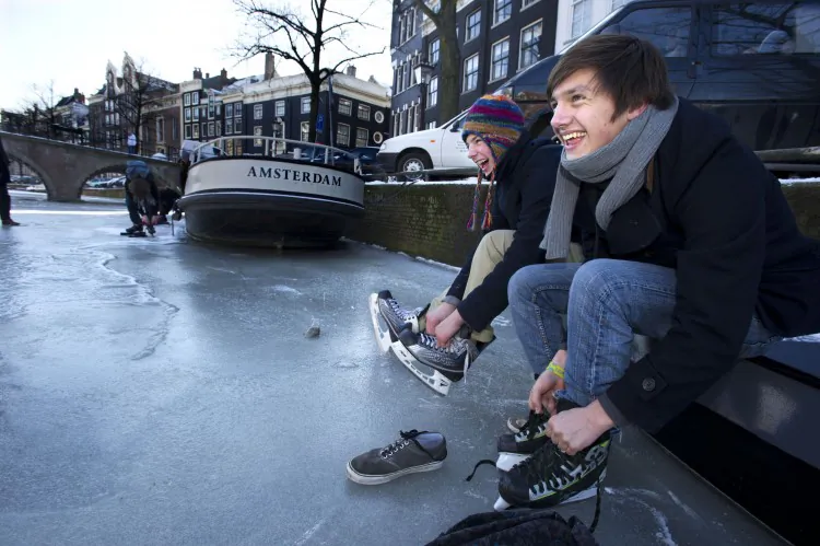 Youth prepare to skate on a frozen canal in Amsterdam, on Feb. 6. The Netherlands famous Eleven Cities Tour on natural ice, will not go ahead for now as hoped because the ice is too thin on parts of the 125-mile "track." (Evert Elzinga/AFP/Getty Images)