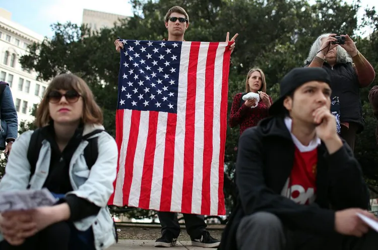 An Occupy Oakland protestor holds an American flag during a demonstration in front of Oakland City Hall on February 6, in Oakland, California. Occupy Oakland protesters are staging a day of action. (Justin Sullivan/Getty Images)